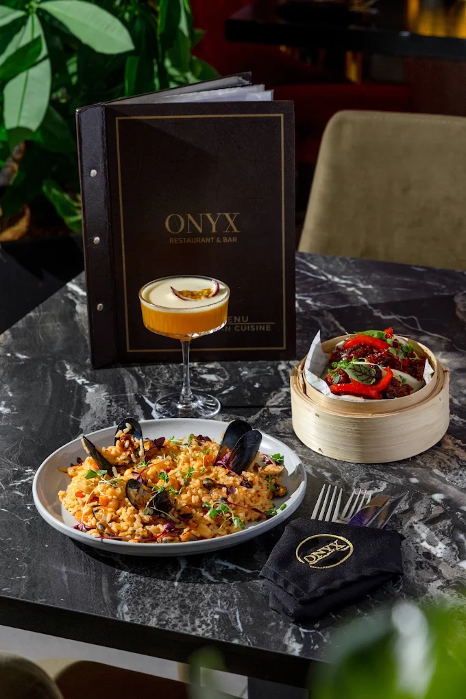 Onyx menu and plated food on a restaurant table