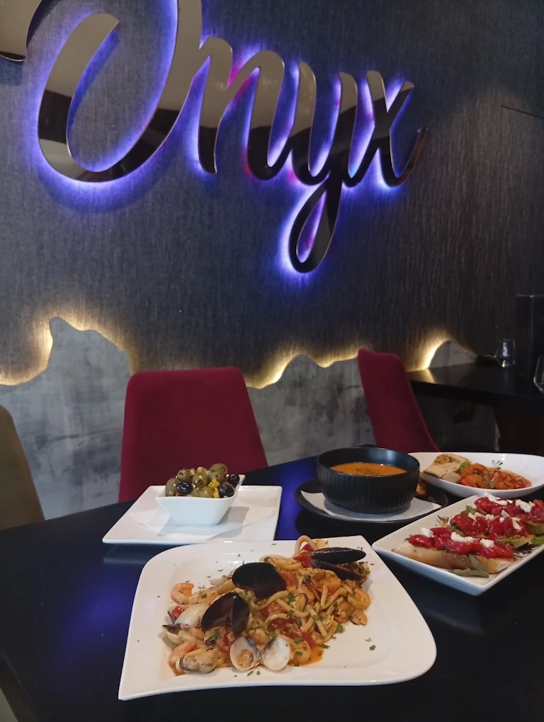 Mixed Onyx dishes and drinks across a table